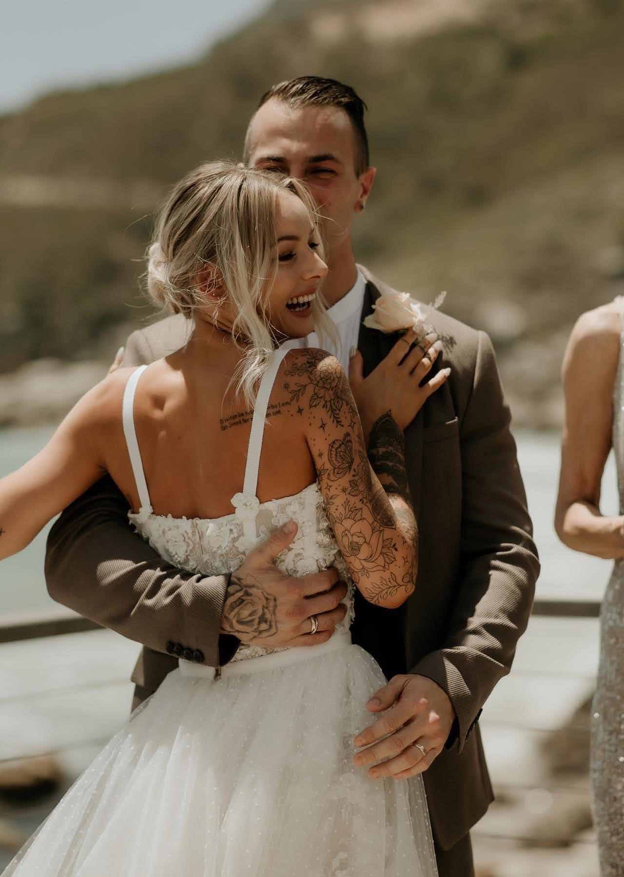The couple embracing, the bride in a strapless gown