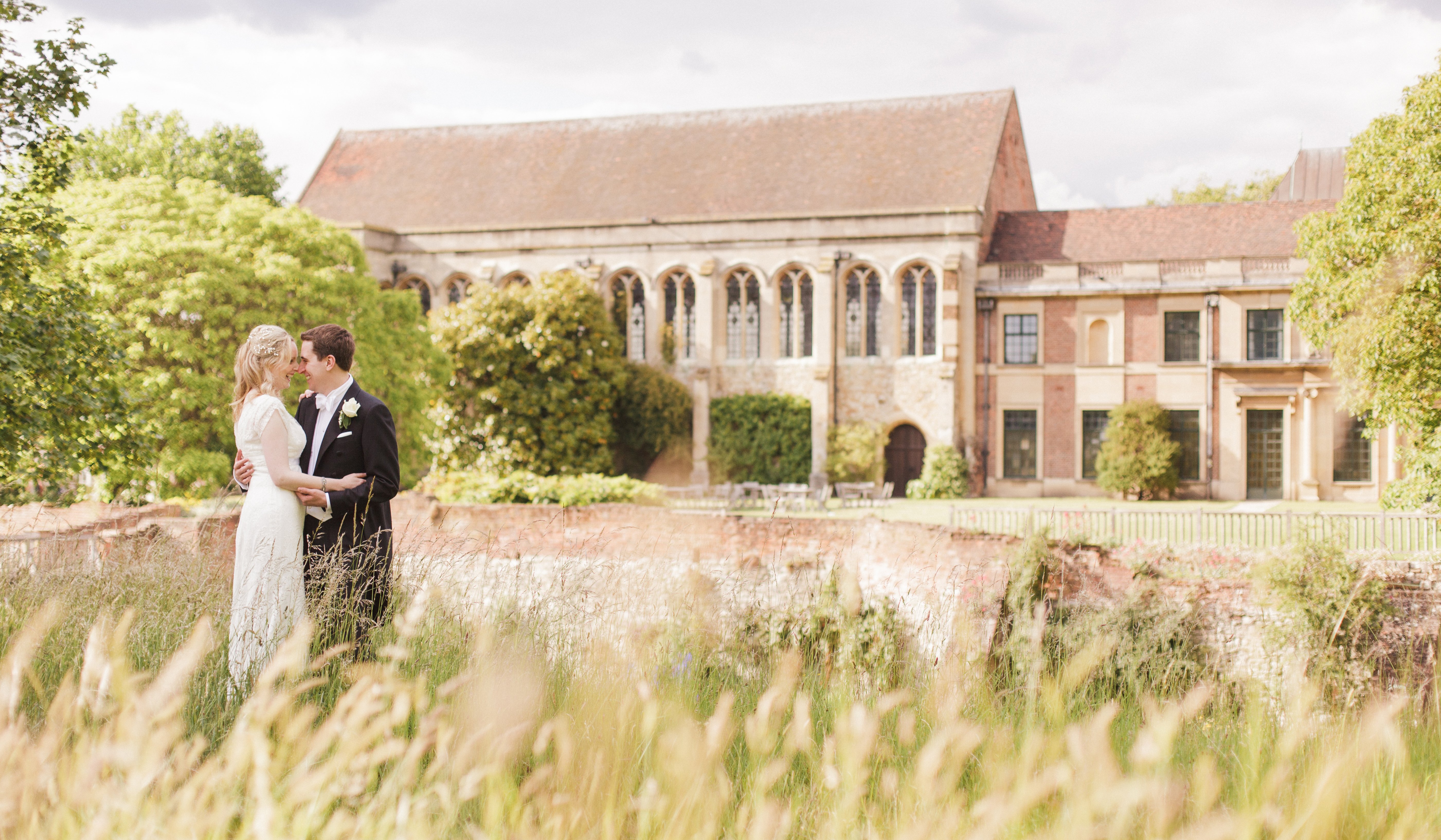 A couple in the meadow, the medieval Great Hall rising behind