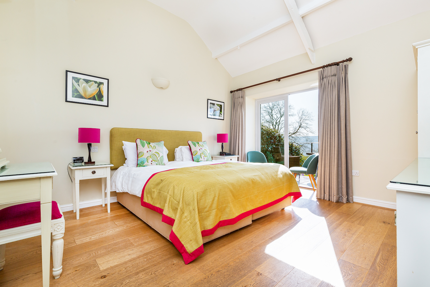 An Original Coach House bedroom, vaulted ceiling and doors to a private balcony
