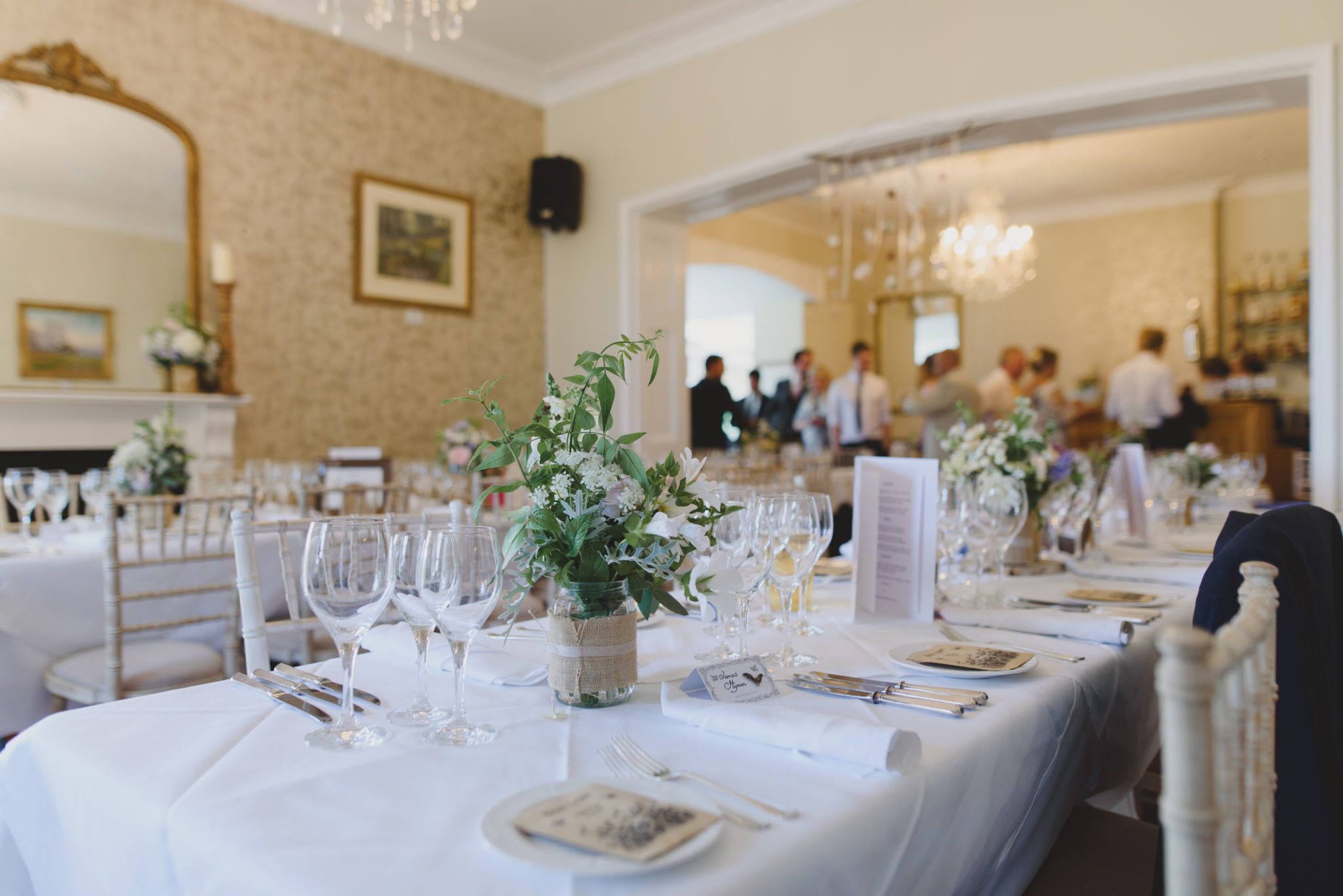 The dining room dressed for a wedding breakfast, foliage centrepieces