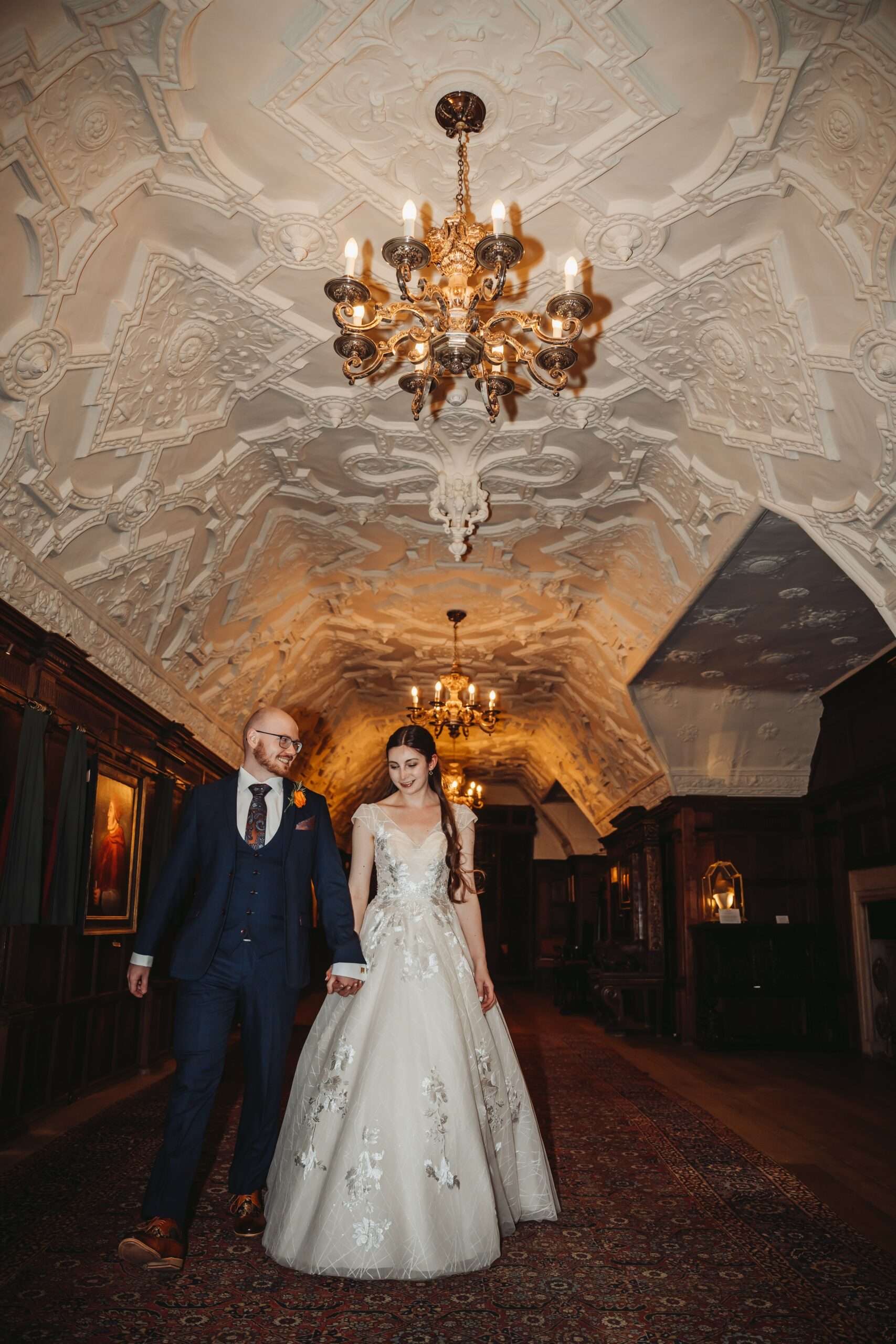 A long banqueting table beneath portraits in the castle Dining Hall
