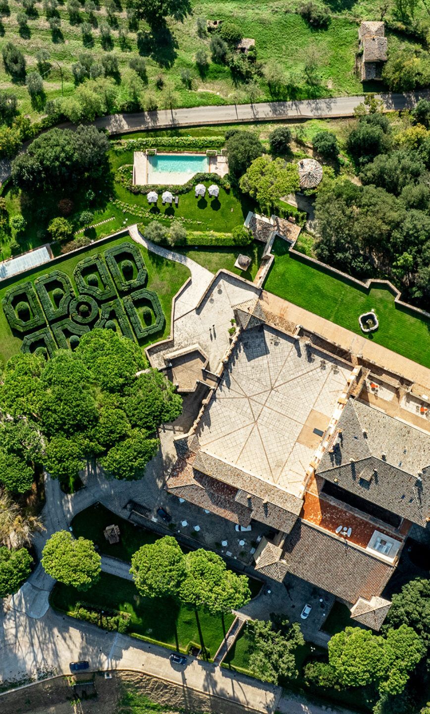 Aerial of the castle, formal garden and outdoor pool, Solfagnano