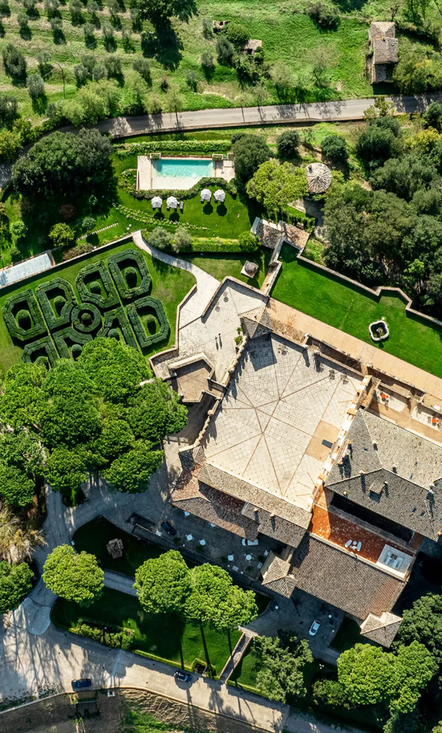 Aerial of the castle, formal garden and outdoor pool, Solfagnano