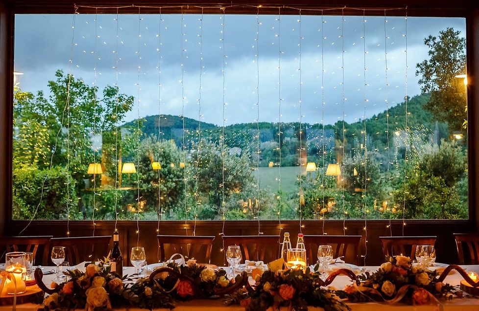 A glass-roofed hall set for a wedding banquet