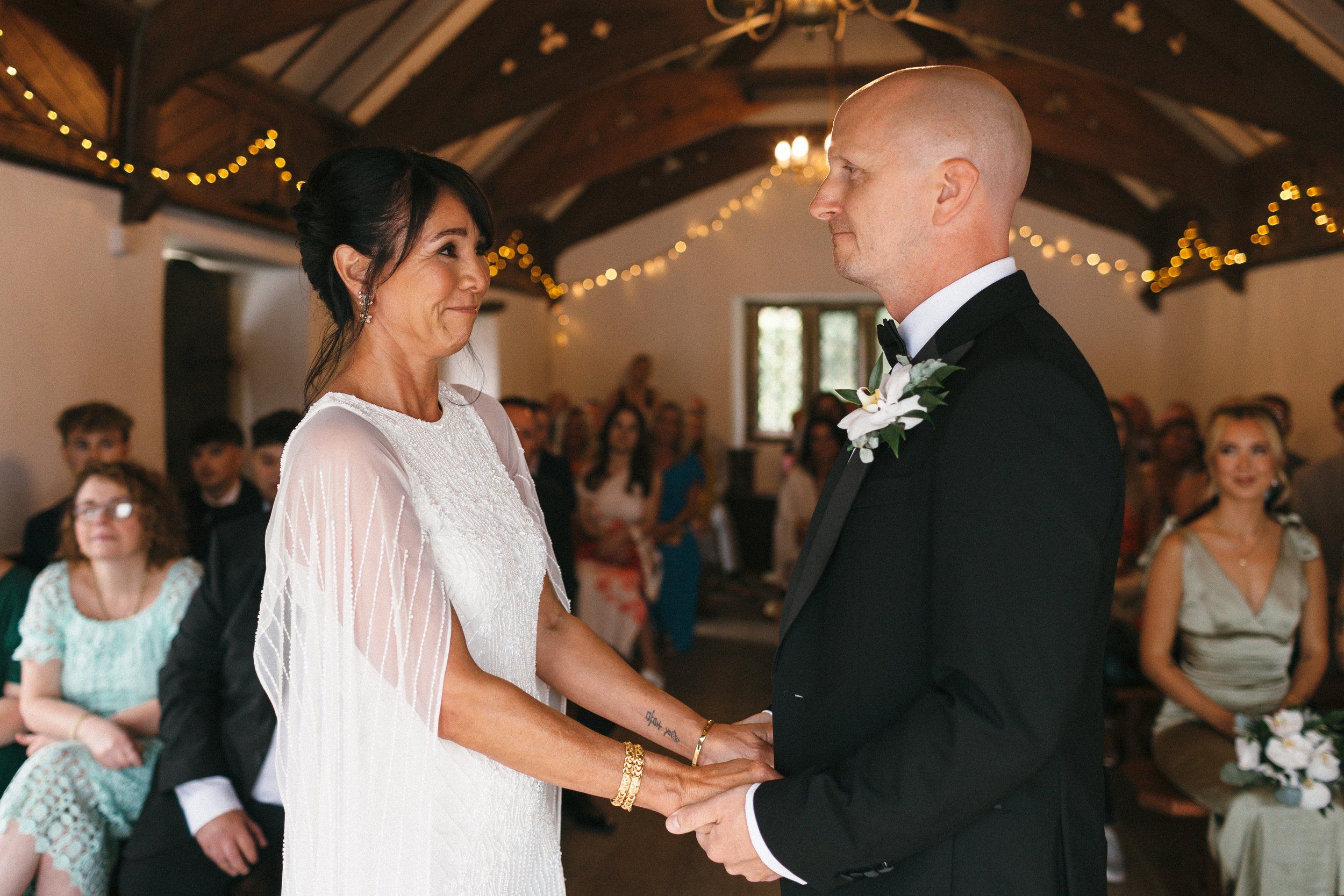An indoor ceremony beneath fairy lights