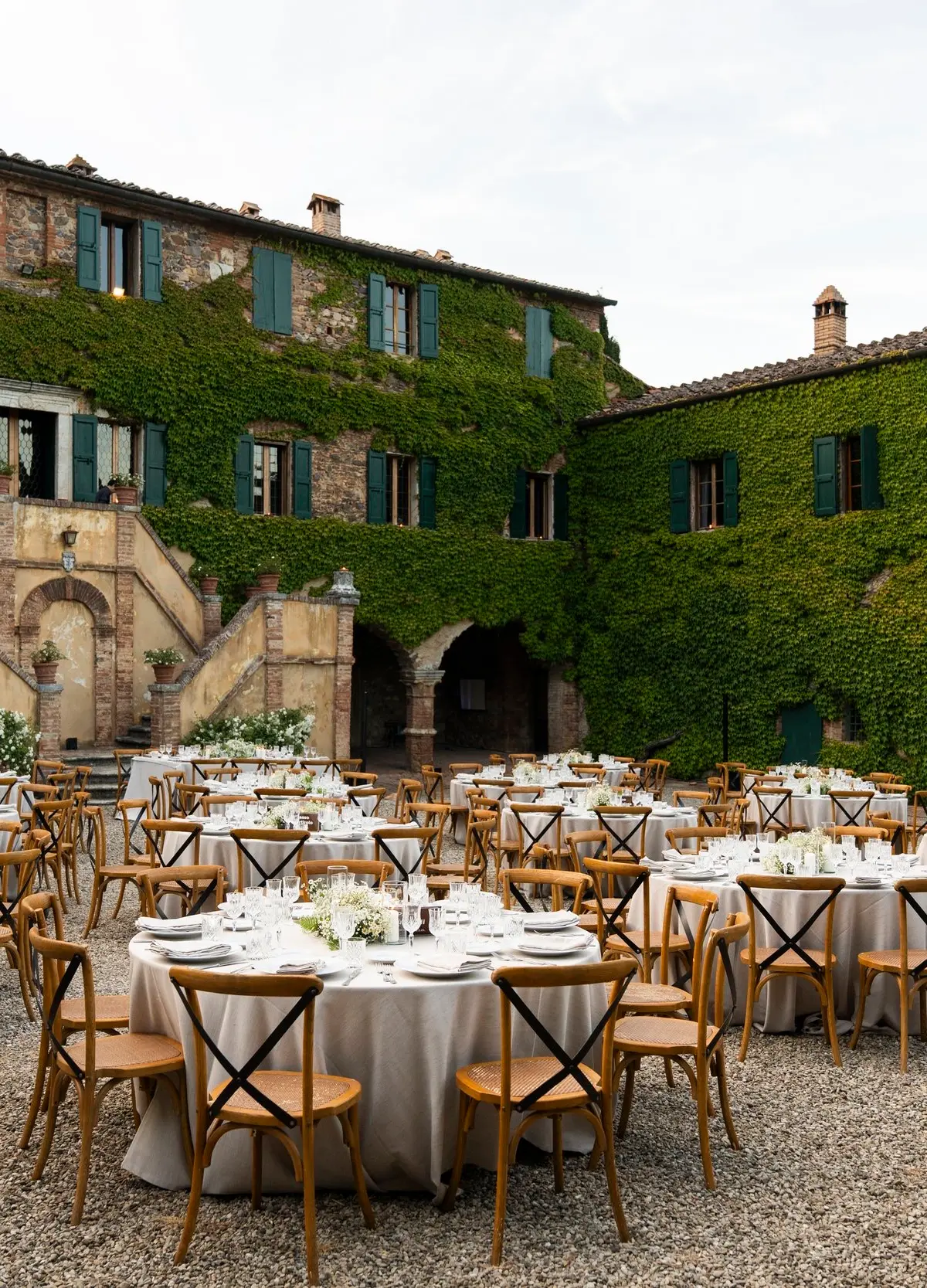 A wedding dinner in the courtyard at dusk, Borgo di Recenza