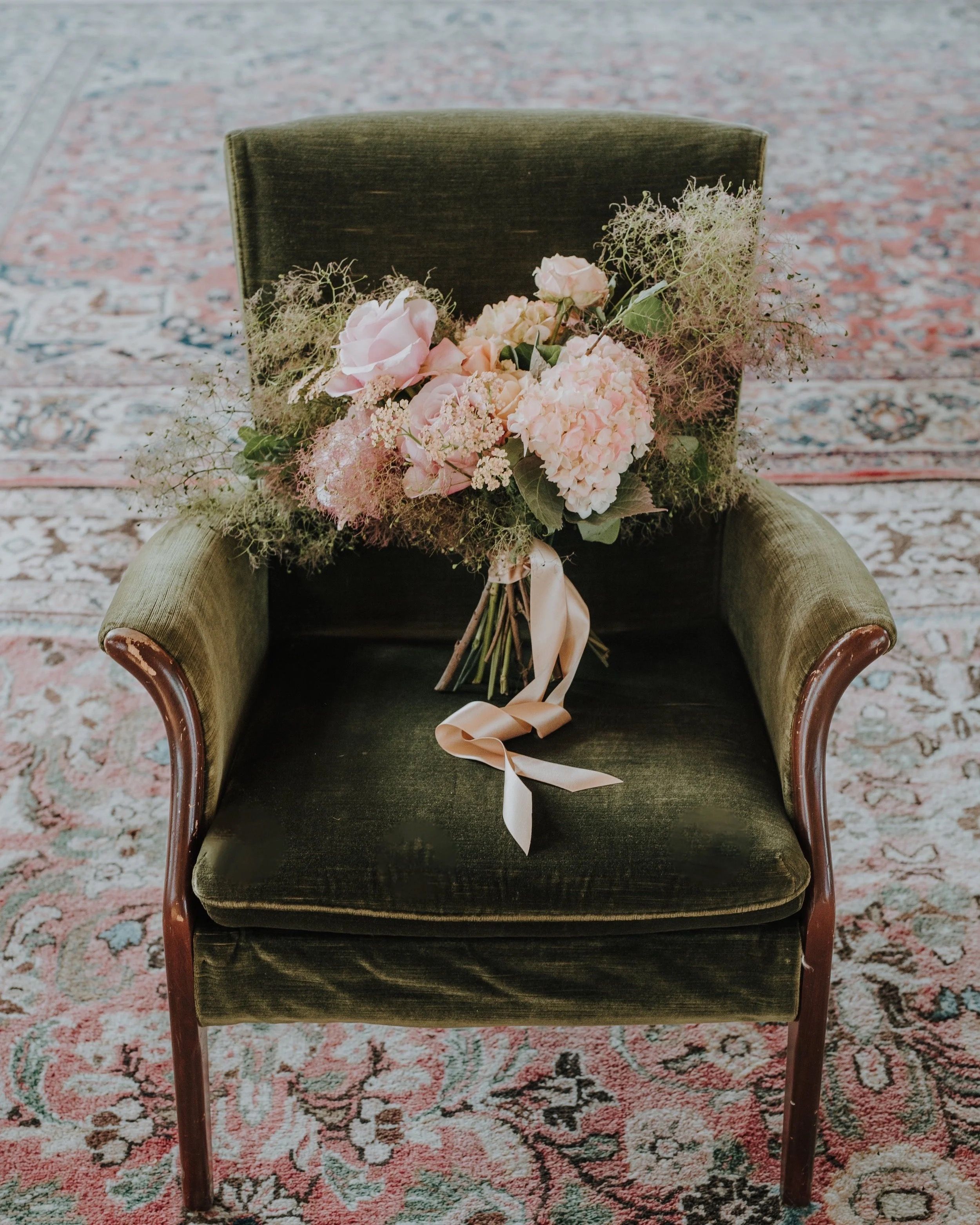 A bouquet of rose and hydrangea, on a velvet chair