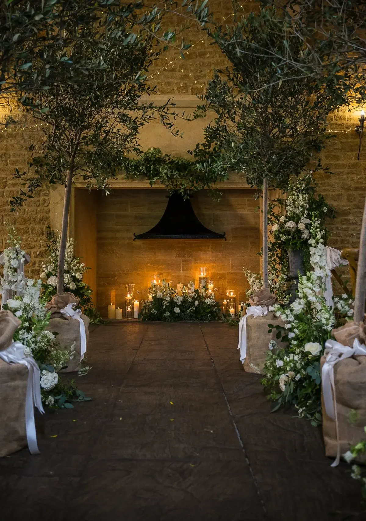 The Tithe Barn dressed with foliage pillars and candlelight