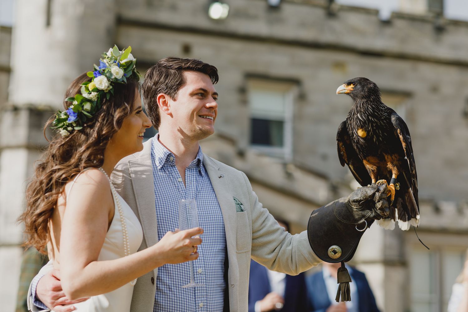 A couple with a Harris hawk during a falconry experience on the estate