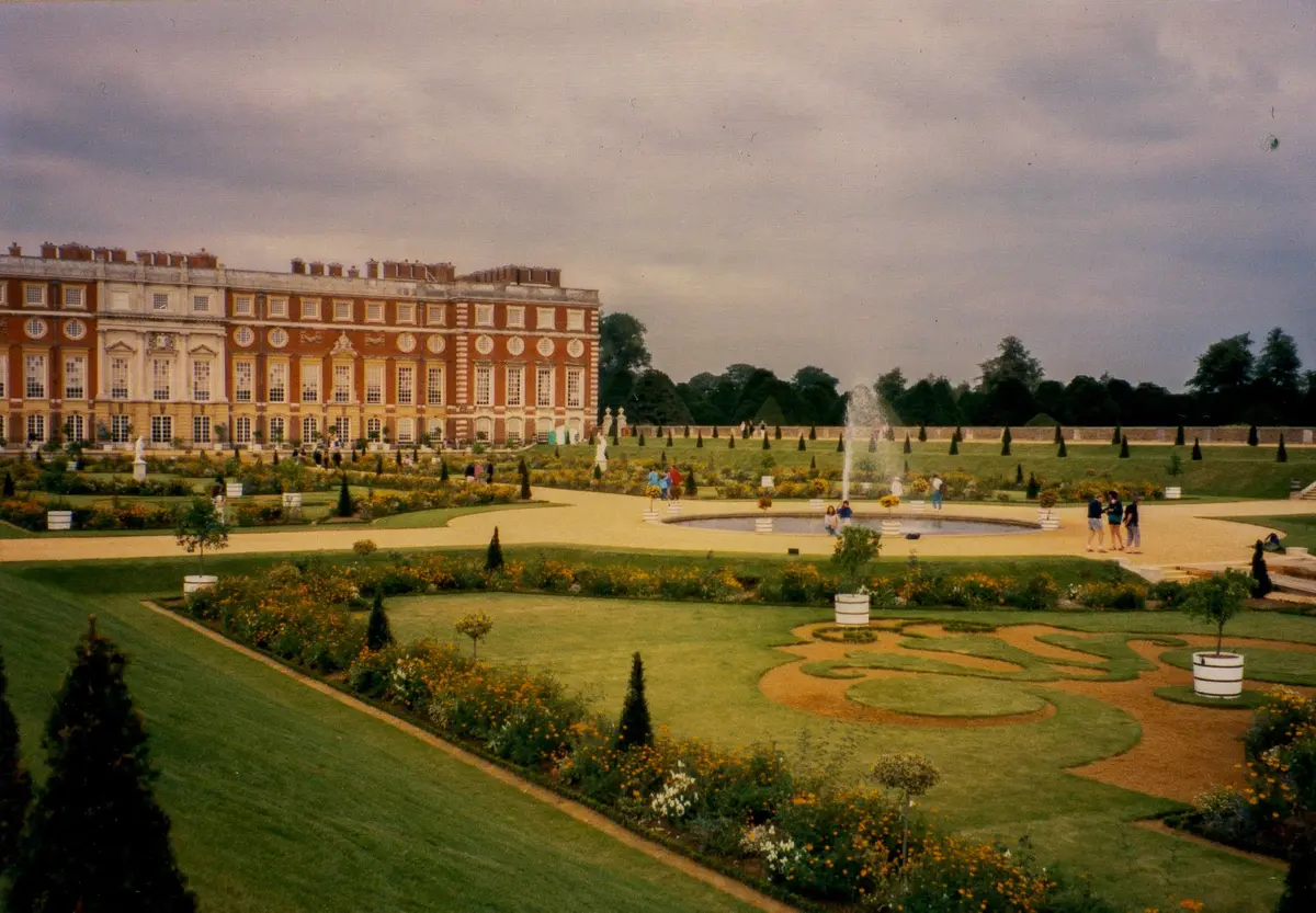 The Privy Garden's clipped parterres before the palace's Baroque south front in golden light, Hampton Court Palace, East Molesey, England