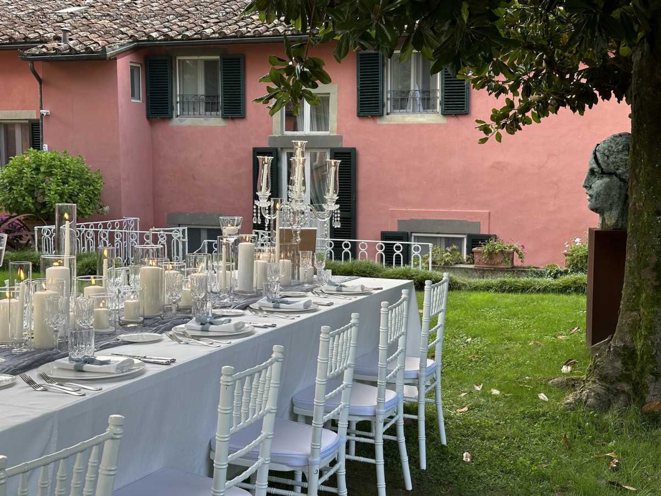 A wedding table on the lawn before the villa