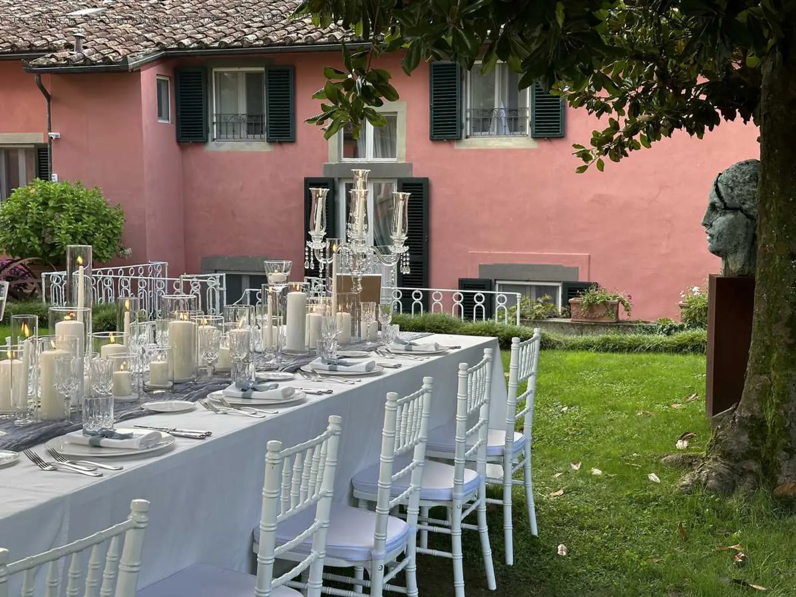 A wedding table on the lawn before the villa