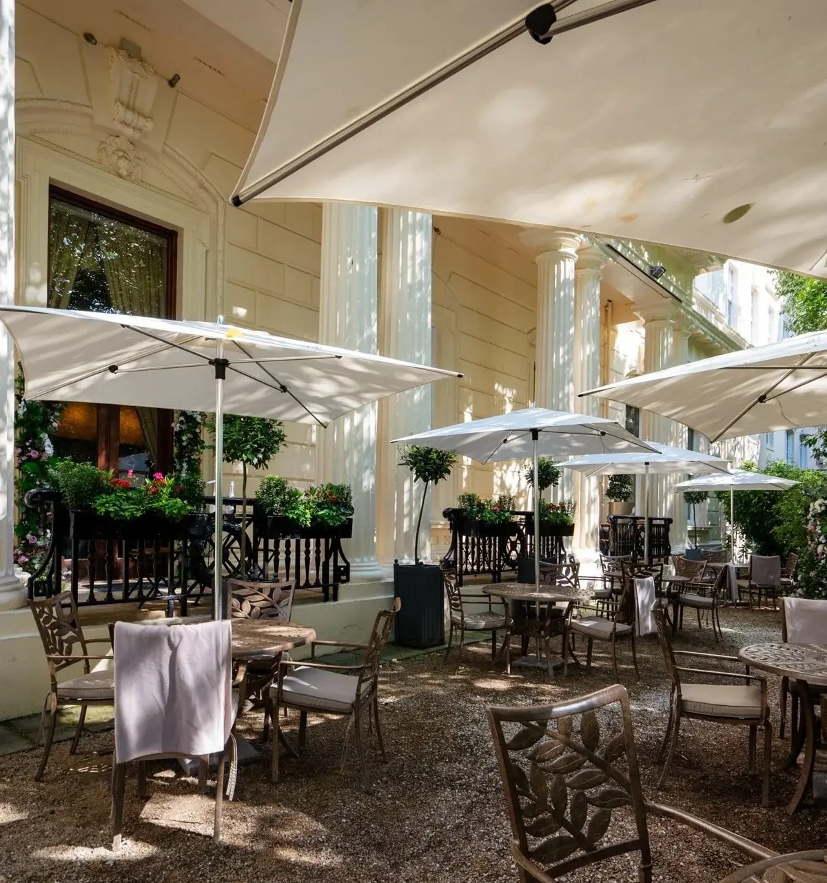 The Terrace under parasols against the Georgian colonnade