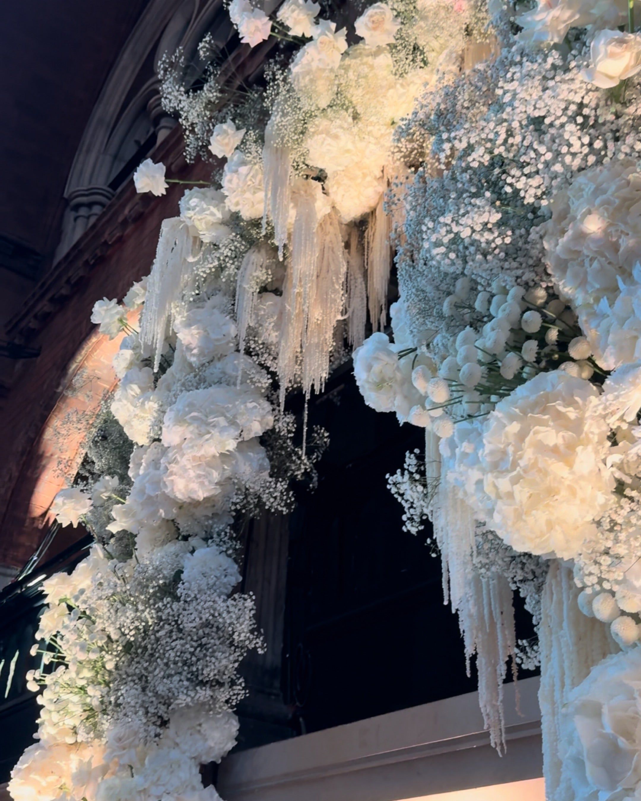 The top of the floral arch, dressed in white, The Londoner