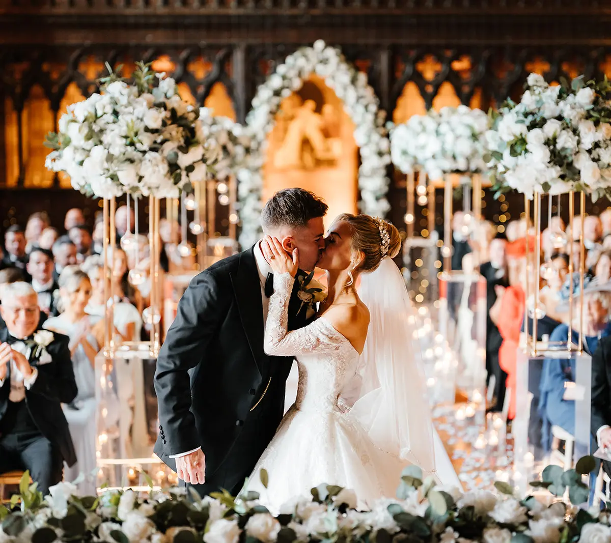 A couple's first kiss at the altar in the Great Hall