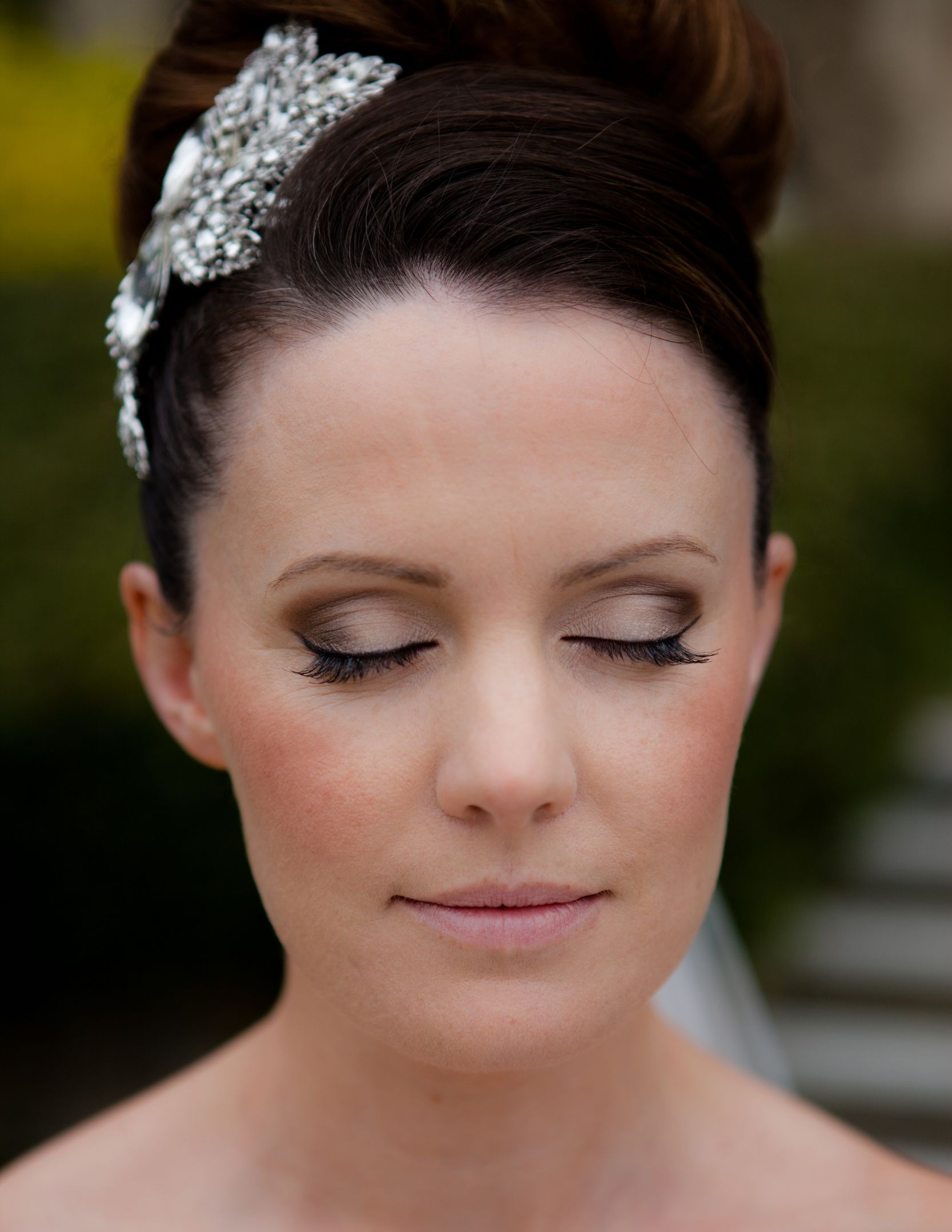 A close bridal portrait, jewelled hairpin and swept-up hair