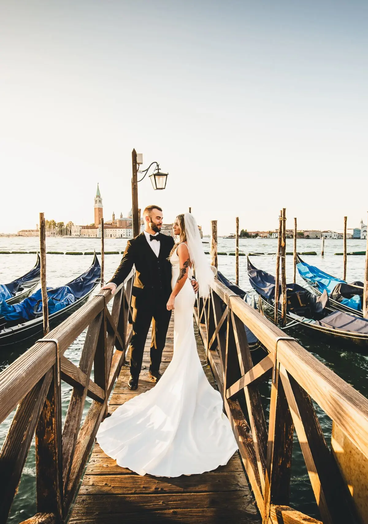 A wooden pontoon between moored gondolas, San Giorgio Maggiore across the water