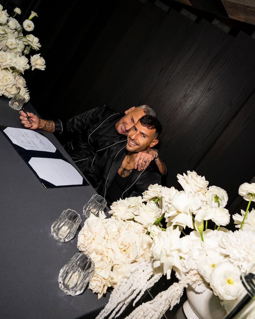 Signing the register among white roses, The Londoner