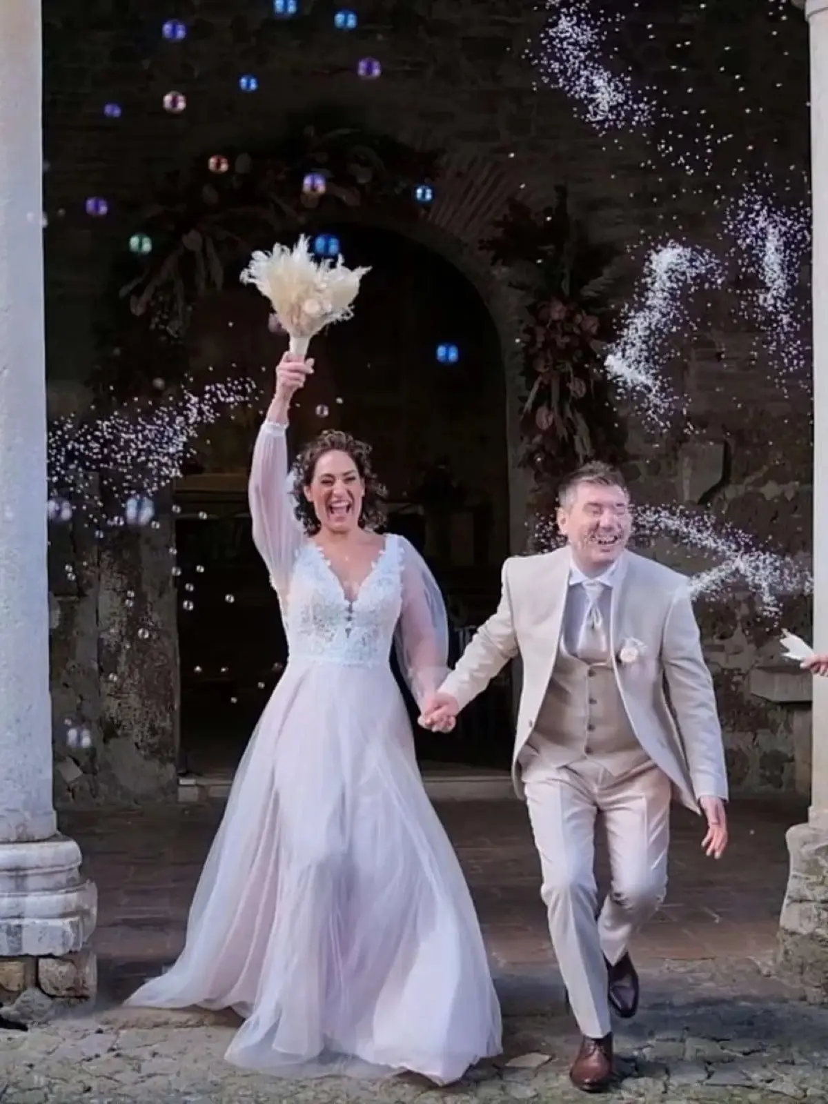 A couple with sparklers, in a Roman colonnade, Eventilab Weddings, Rome, Italy