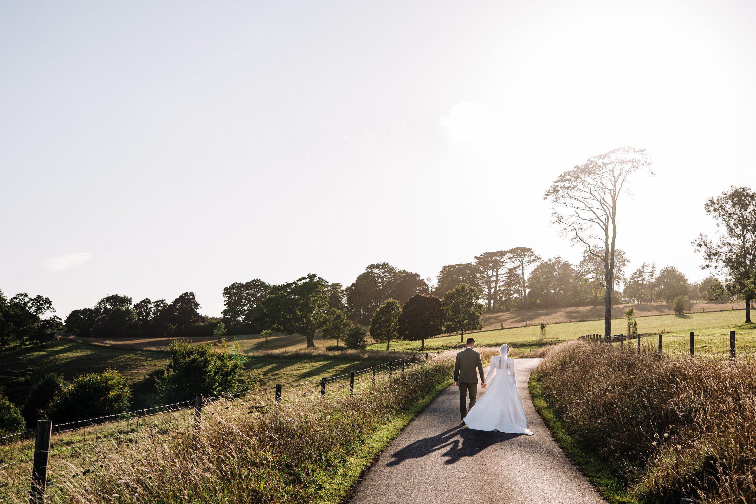 A couple on a country lane at golden hour
