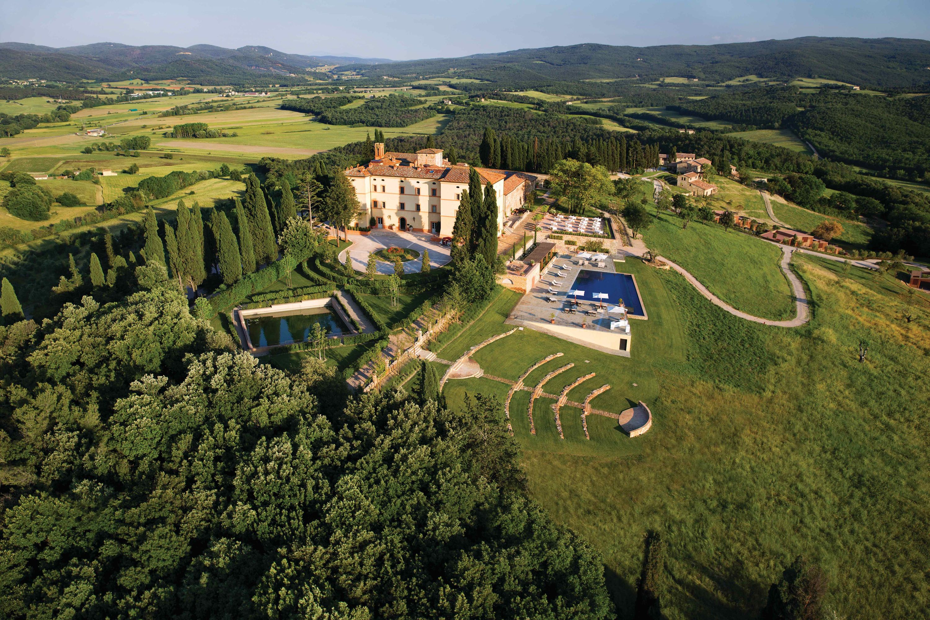 The estate and infinity pool at Castello di Casole, a Belmond hotel in the Val d'Elsa hills near Siena