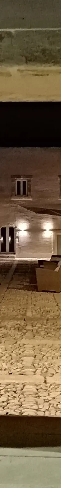 The entrance at night, a stone doorway opening onto a lit interior