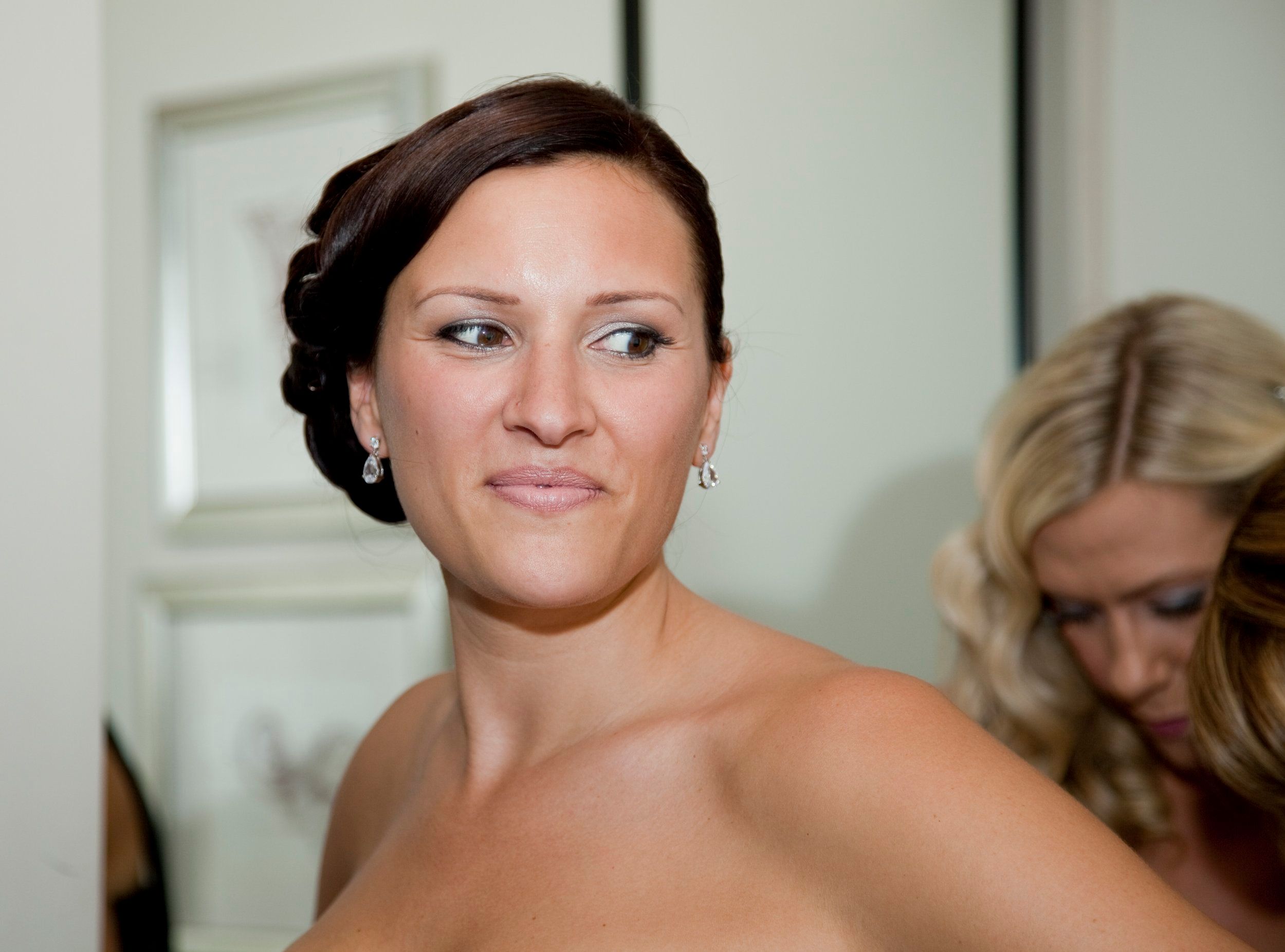 A bridal portrait, sleek low bun and drop earrings