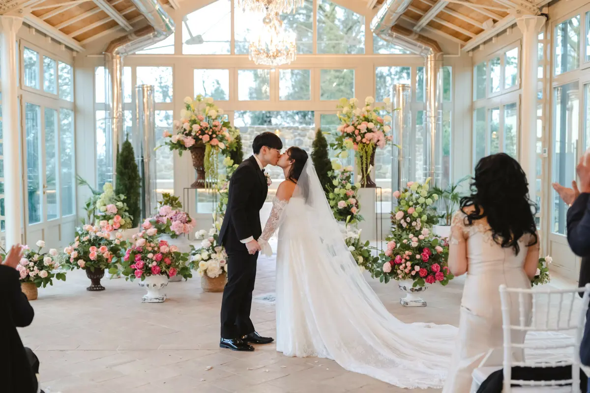 The kiss at the end of the glasshouse aisle, the veil the length of the floor