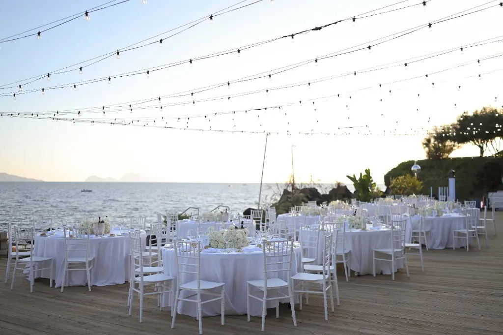 Outdoor tables by the sea at sunset, Villa Balke