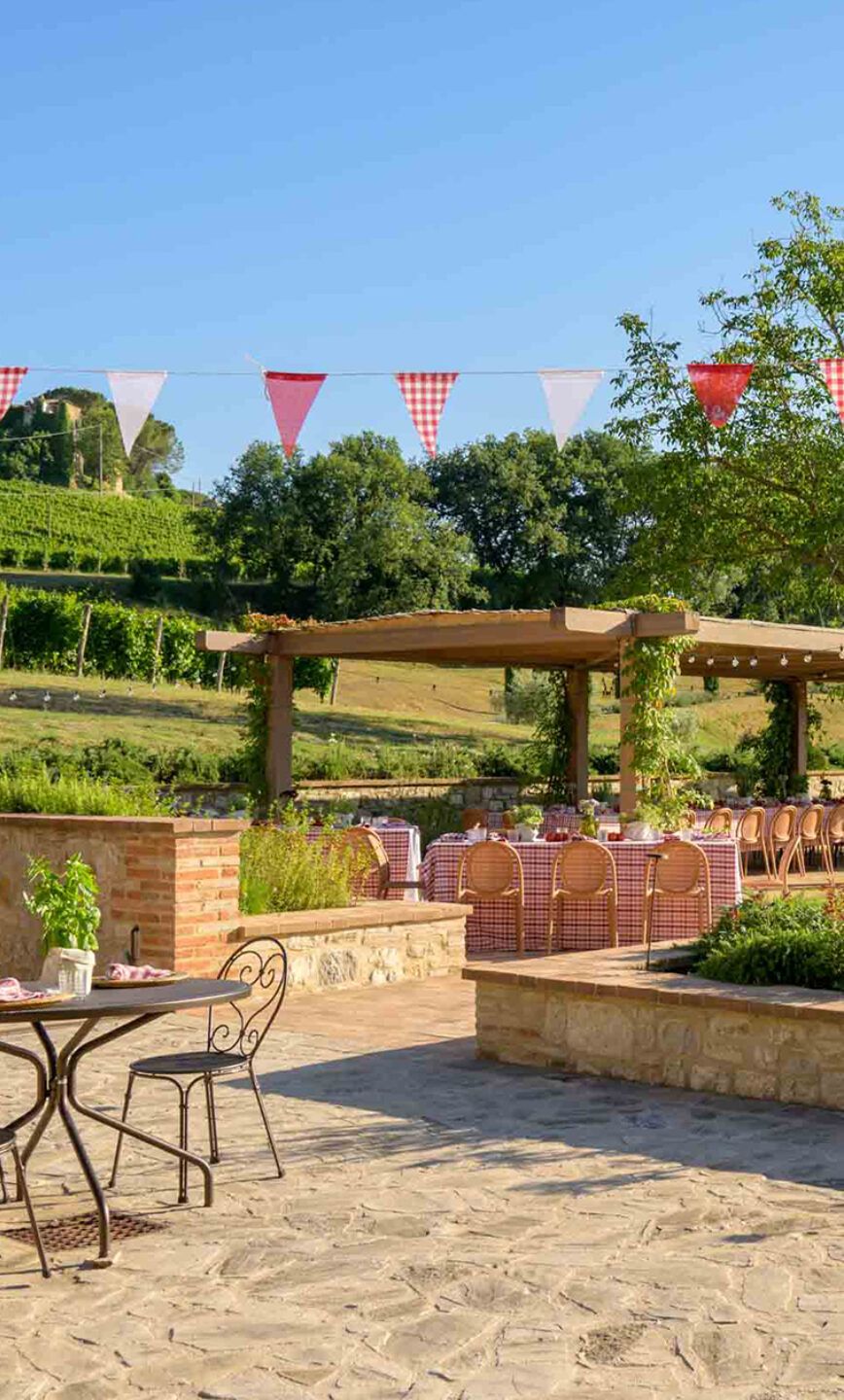 The cantina terrace with pergola and vineyard views, al-fresco dining