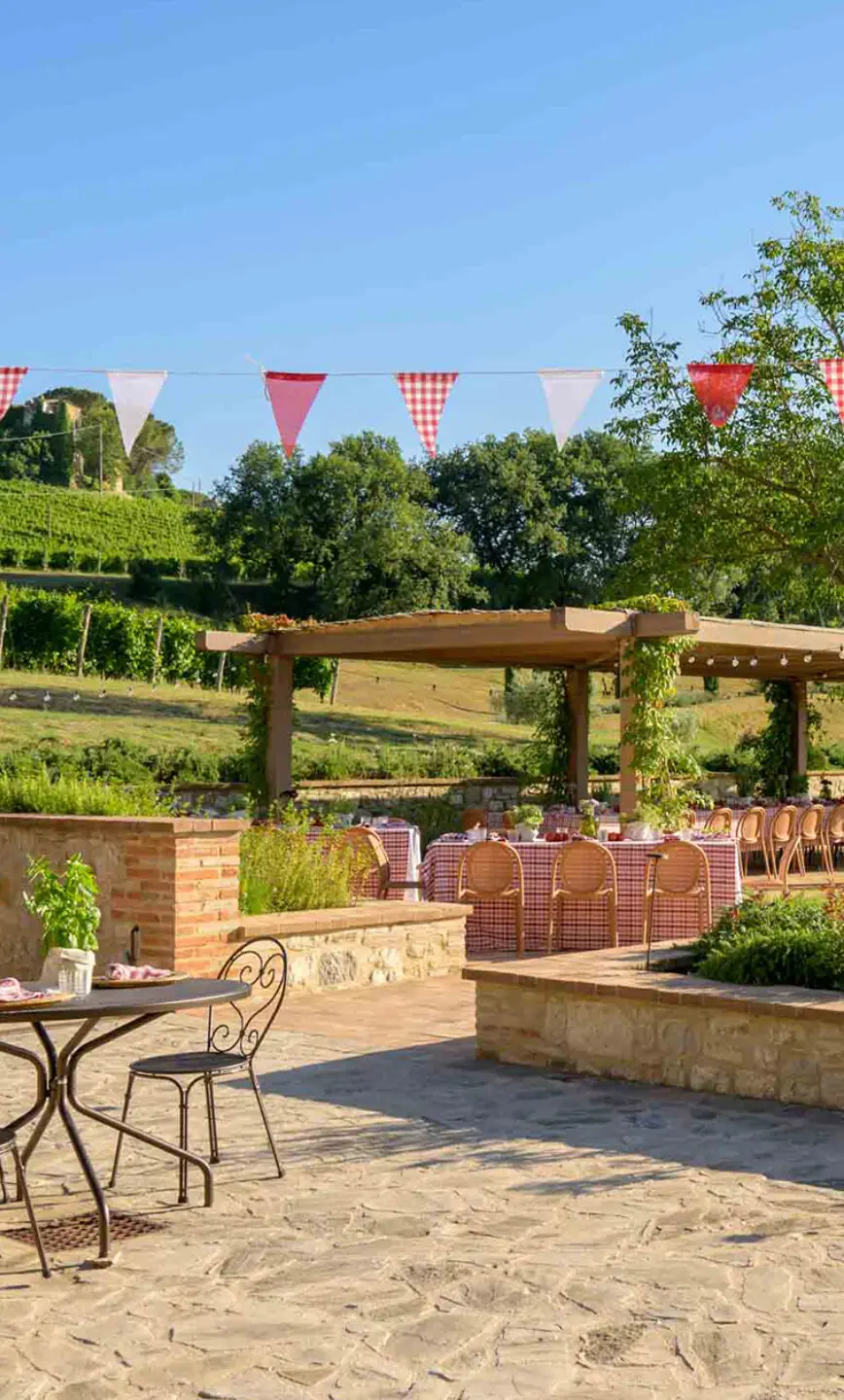 The cantina terrace with pergola and vineyard views, al-fresco dining