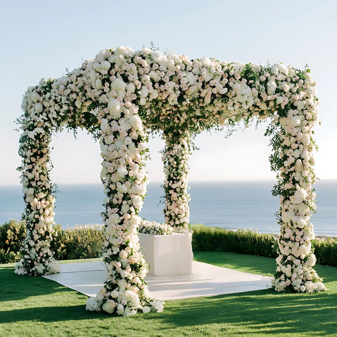 A white and blush ceremony arch, overlooking the Greek coast, Farima Perry Florals and Events, London, England