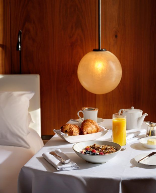 A room-service breakfast dressed on white linen in a guest room