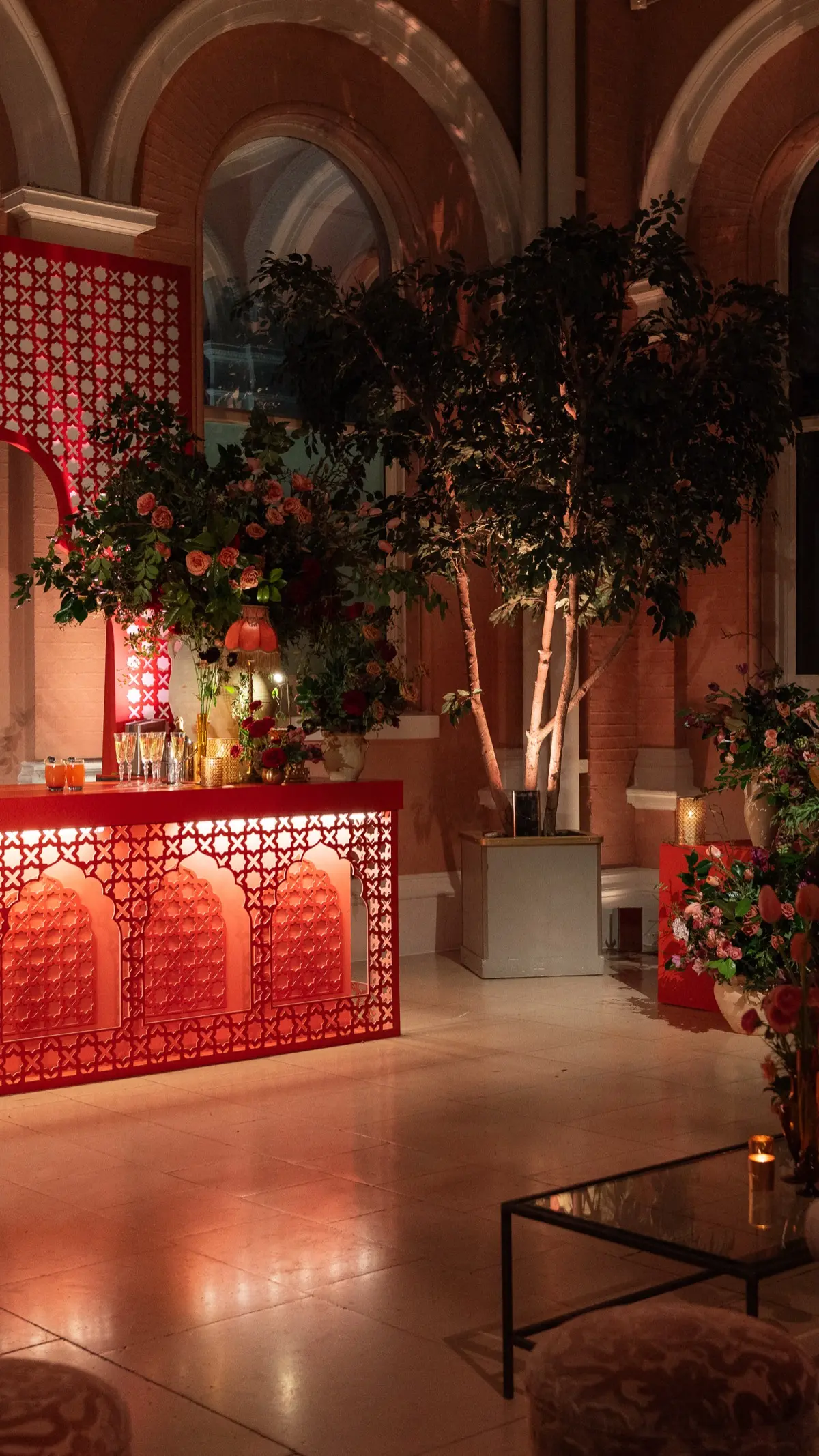 The scarlet fretwork bar in the glass-roofed Courtyard at night