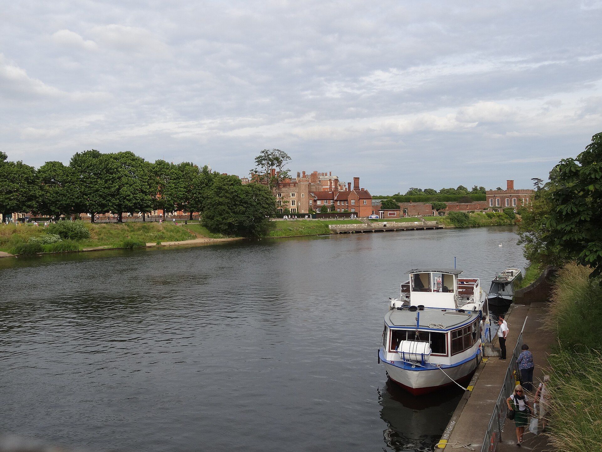 A pleasure boat moored on the River Thames below the palace