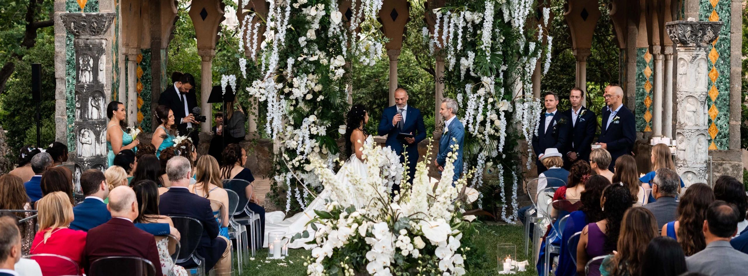 A symbolic ceremony beneath a white floral canopy, Villa Cimbrone, Ravello