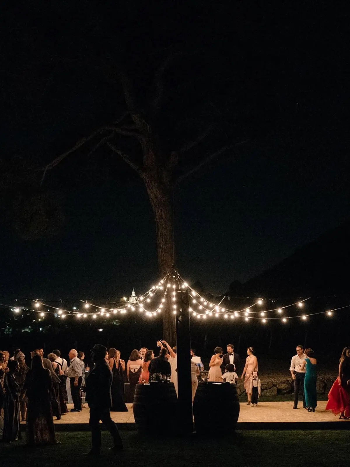 A night dance floor lit under string lights