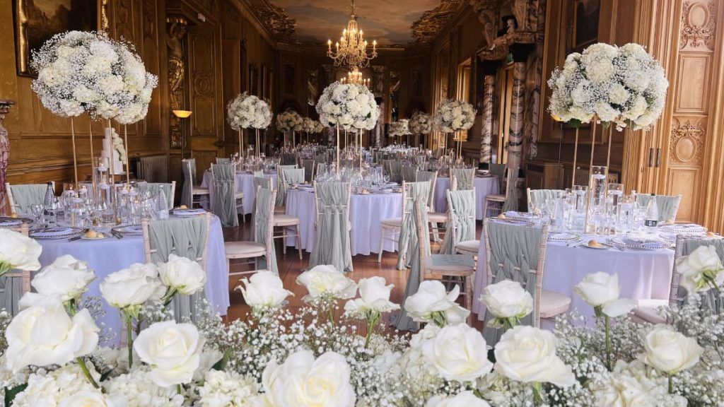 A reception dressed in abundant white roses and gypsophila