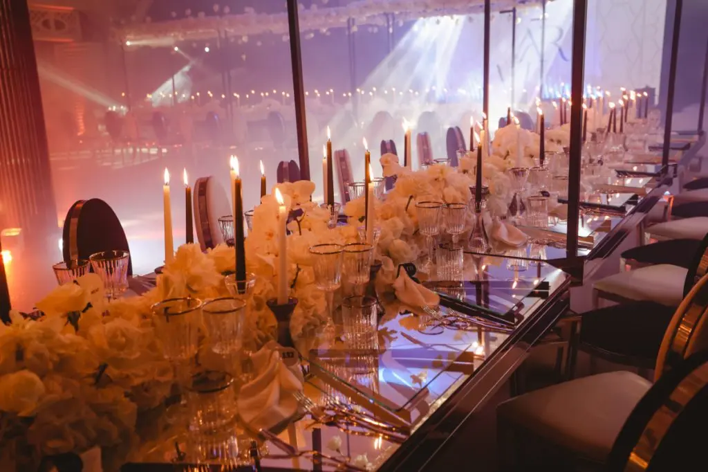 Candlelight and white peonies down the length of the table