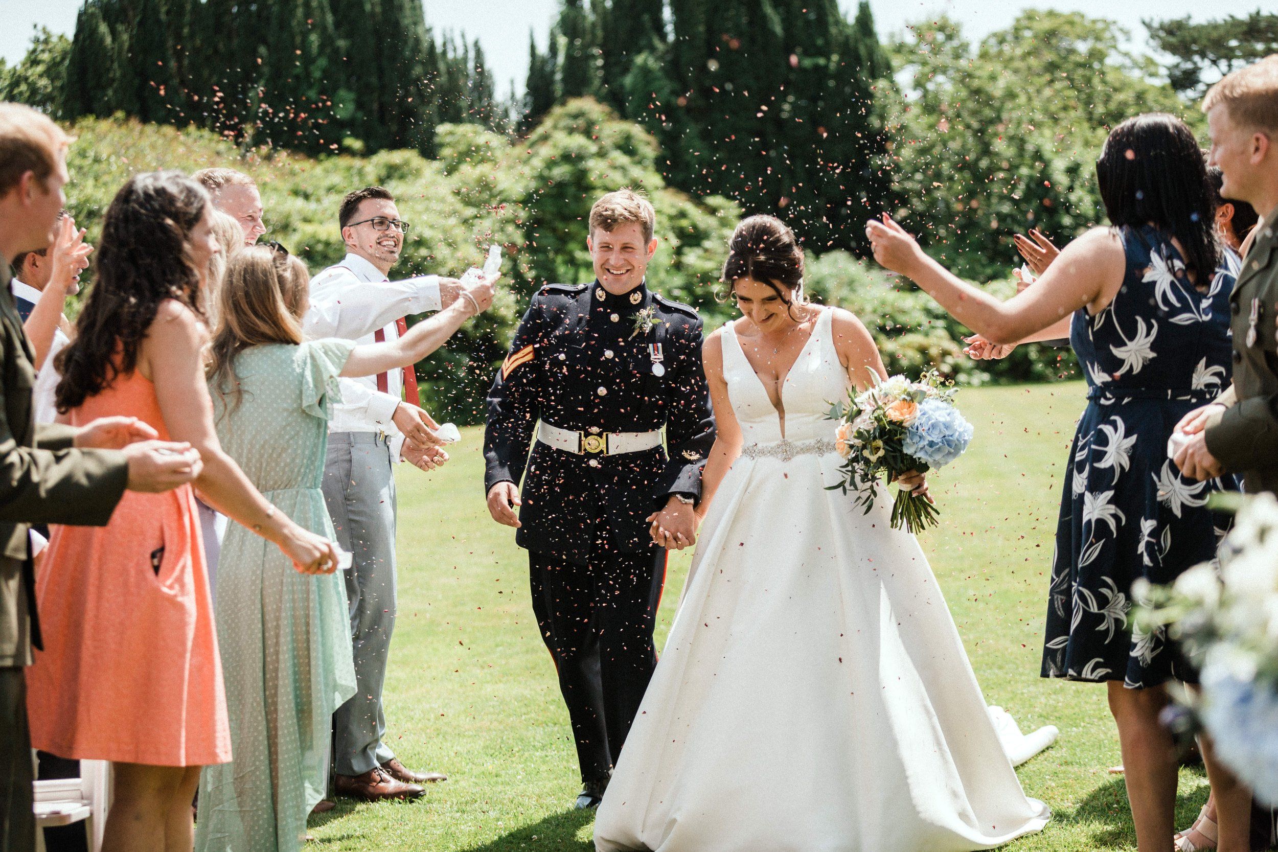 Confetti as the newlyweds walk through their guests, Pentillie Castle, Saltash, England