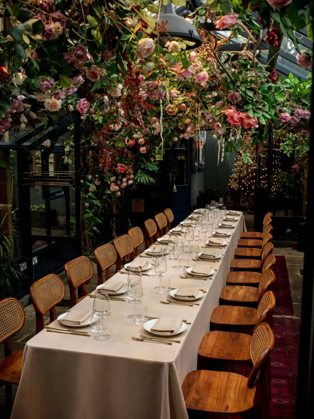 The long table running the length of the blossom-hung glasshouse