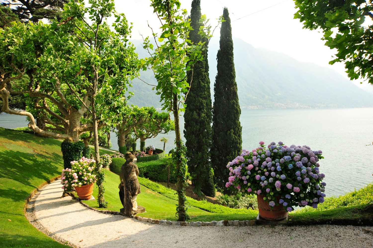 The gardens on the Lavedo peninsula, cypresses and hydrangeas, Lake Como on both sides, Villa del Balbianello