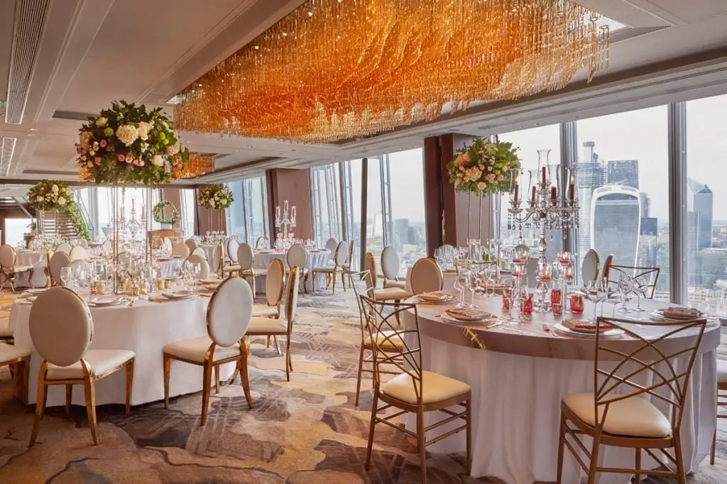 The reception under the amber chandelier, tables the length of the room