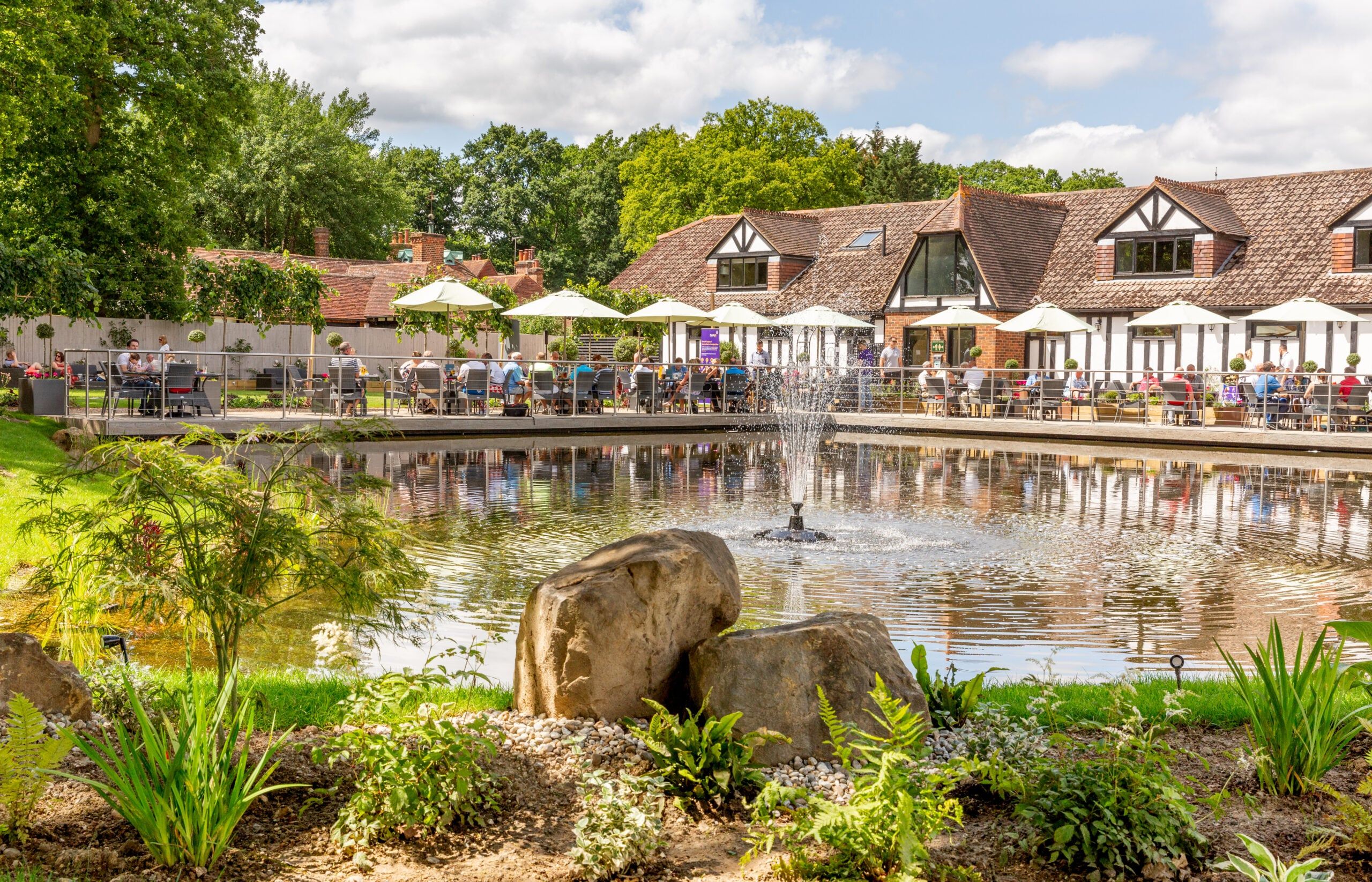 Tables and parasols on the lakeside restaurant terrace beside the water