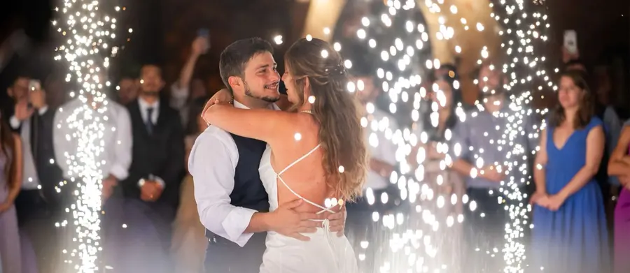 A couple with firework fountains, at the close of the night