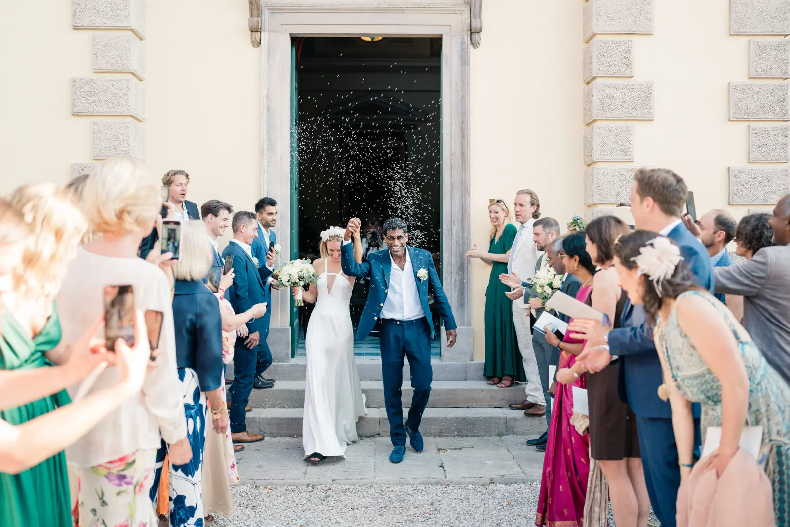 A bride and groom leaving a consecrated villa chapel