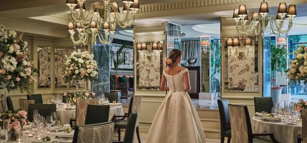 A bride in the Michelin-starred Dining Room amid florals and chandeliers