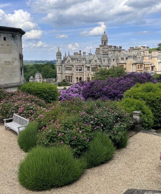 Harlaxton's Jacobethan skyline of pinnacles and gables rising above the terraced flower gardens