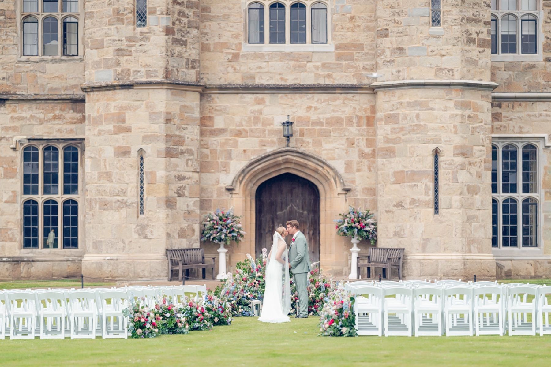 A Couple Beneath a Floral Arch at Leeds Castle, a Cultural Celebration