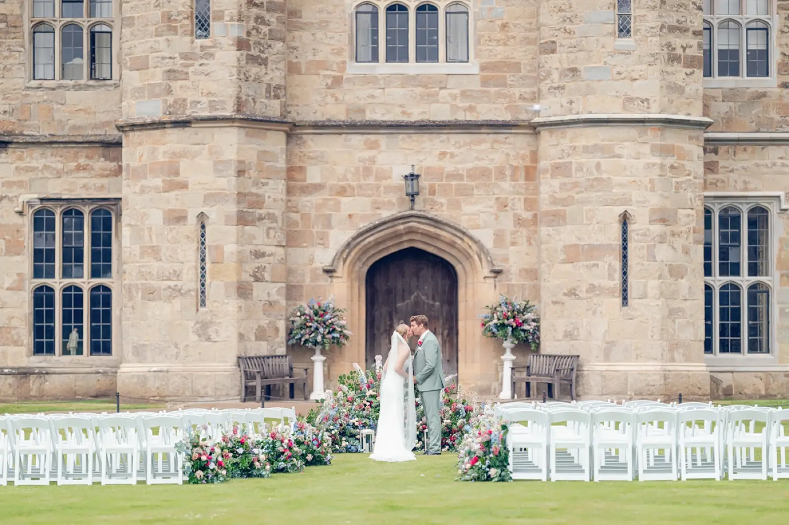 A Couple Beneath a Floral Arch at Leeds Castle, a Cultural Celebration